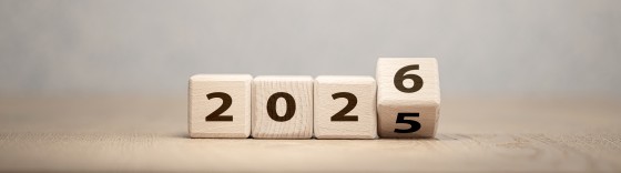 Wooden cubes with numbers forming the year 2025, turning into 2026. Concept of new year, time change, goals, progress, and transition to the future.