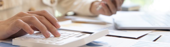 Financial businesswomen use laptop and smart phone to analyze marketing strategies and real estate data to reduce company taxes for their customers, Accounting and Tax concept.