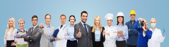 people, profession, qualification, employment and success concept - happy businessman over professional workers showing thumbs up over blue background